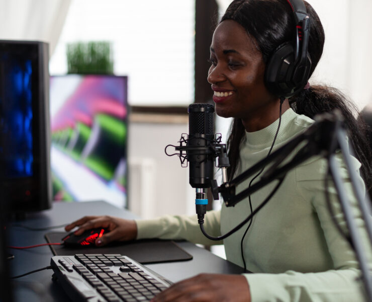 Premium Photo  Person streaming video games online with live chat. player  using headphones and microphone on computer, to play gameplay on live  stream. man broadcasting game with equipment at desk.