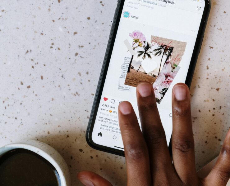 Un teléfono inteligente está sobre un escritorio con el *feed* de Instagram abierto. Una persona se desplaza por él.