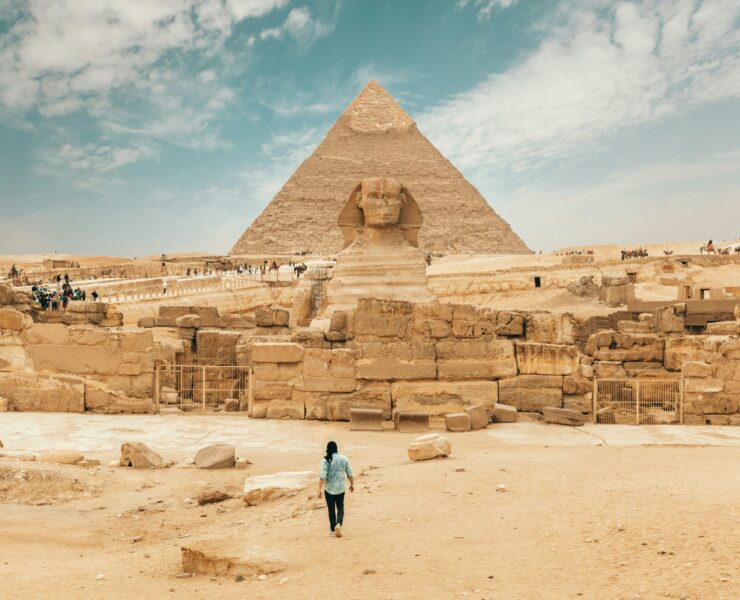An image showing the great pyramid of giza with the sphinx in the foreground.